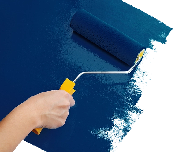 Close up of hand applying blue paint to surface with roller.