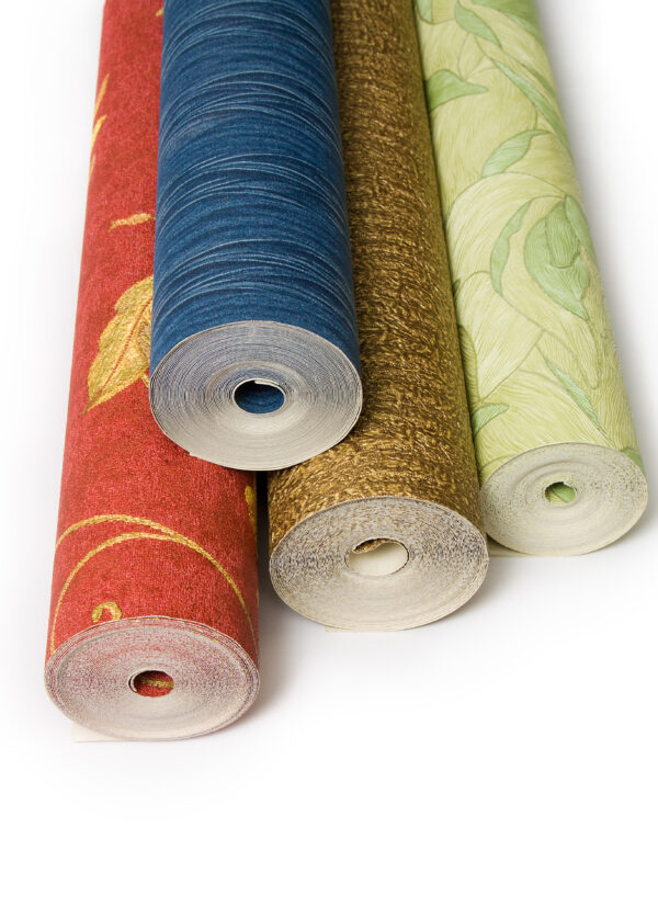 Rolls of wallpaper with different textures and colours against white background.