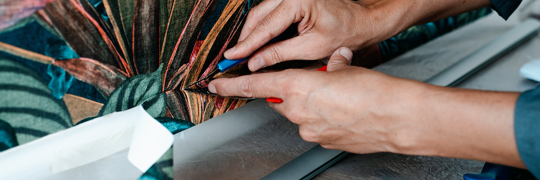 Close up of man professionally applying statement wallpaper.